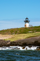 Pond Island Lighthouse by Rocky Shore in Maine